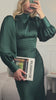 Video of the emerald green midi dress with bow tie back — modelled in motion