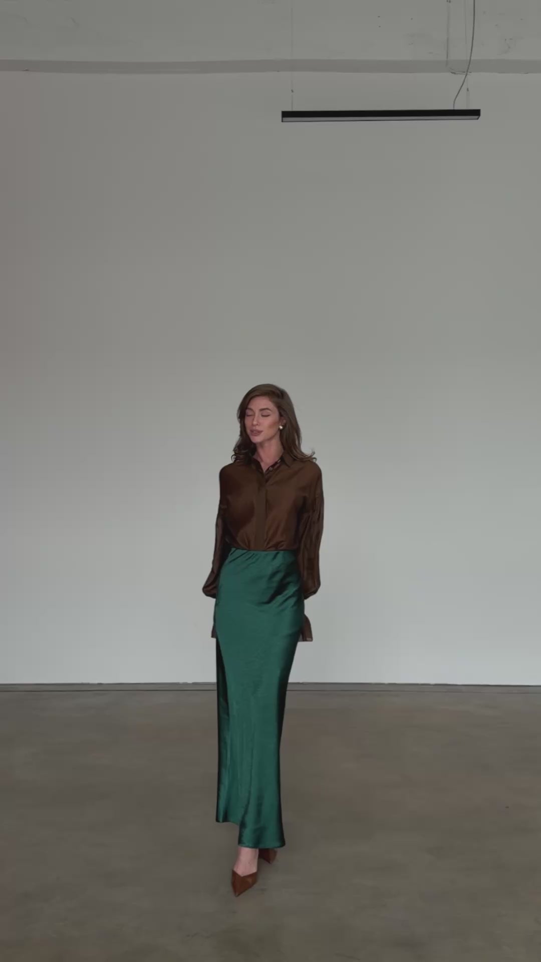 Forest green satin bias cut midi skirt with fluid drape modelled in motion — EvolveUA