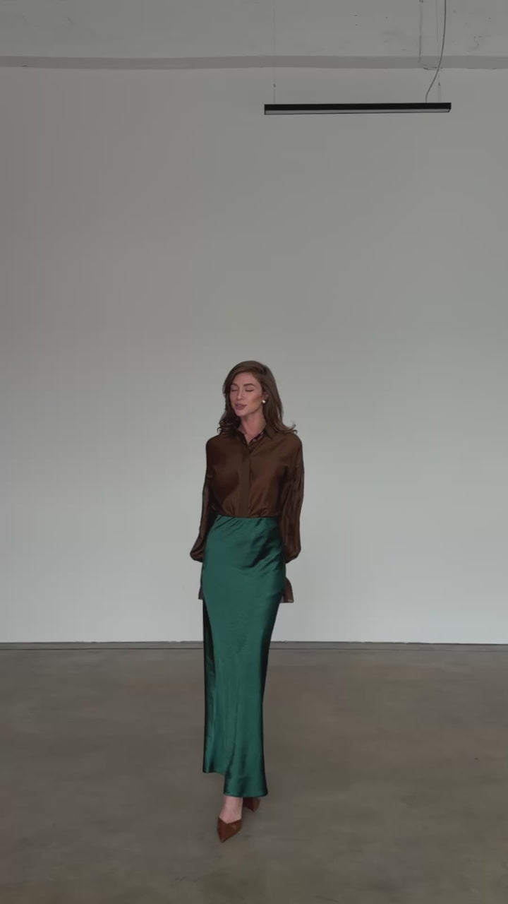 Forest green satin bias cut midi skirt with fluid drape modelled in motion — EvolveUA