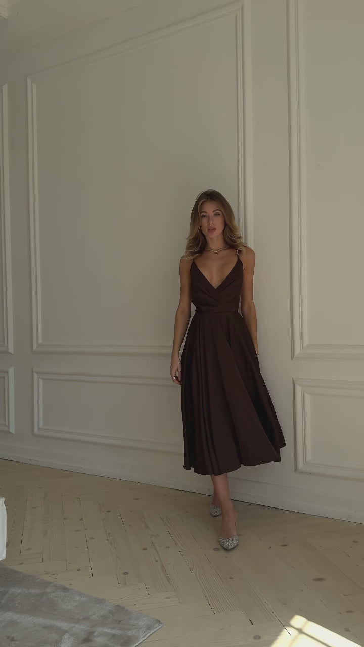 Chocolate brown silk slip midi dress with deep V-neck and open back modelled in motion — EvolveUA