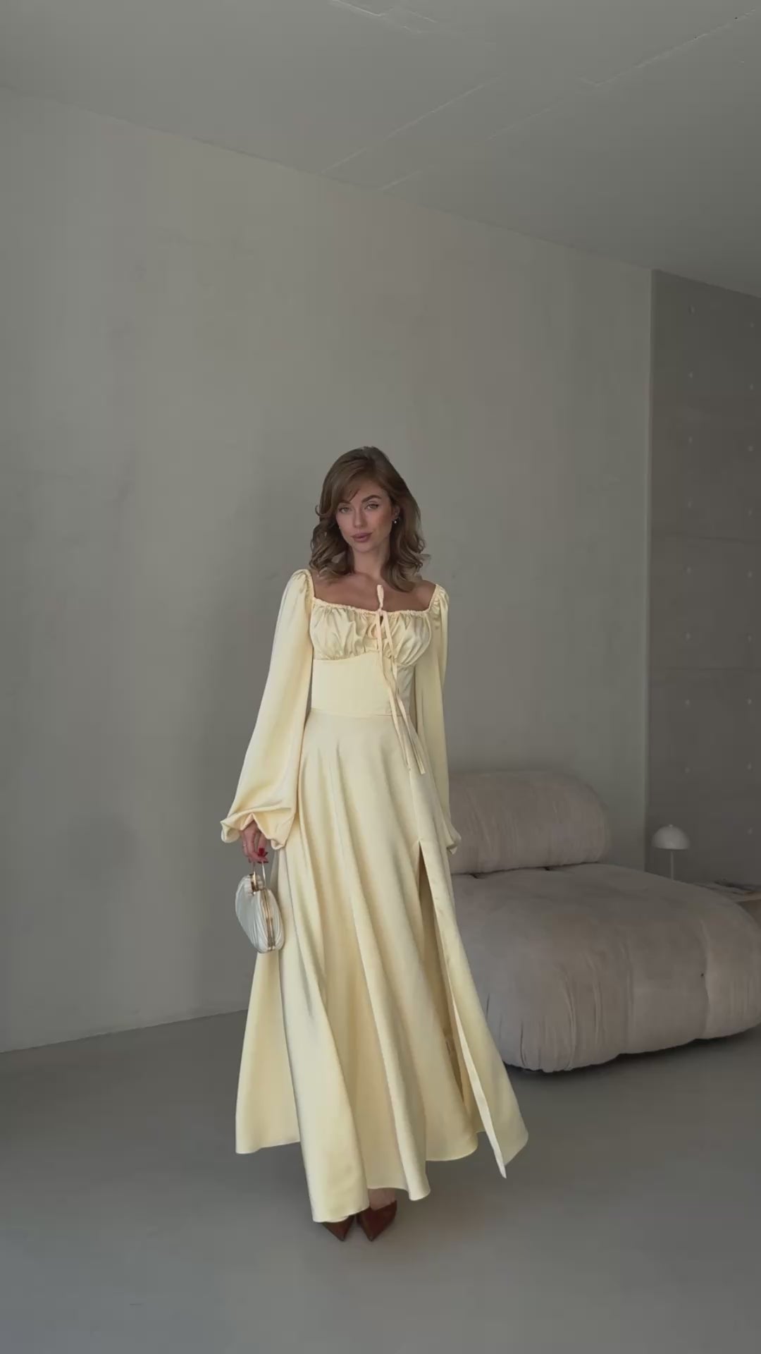 Elegant butter yellow silk gown with a front leg slit and bishop style sleeves.