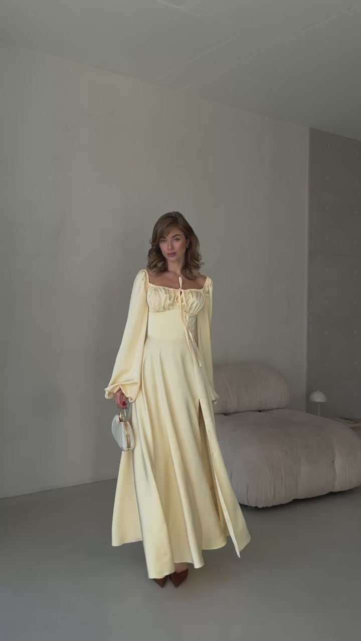 Elegant butter yellow silk gown with a front leg slit and bishop style sleeves.