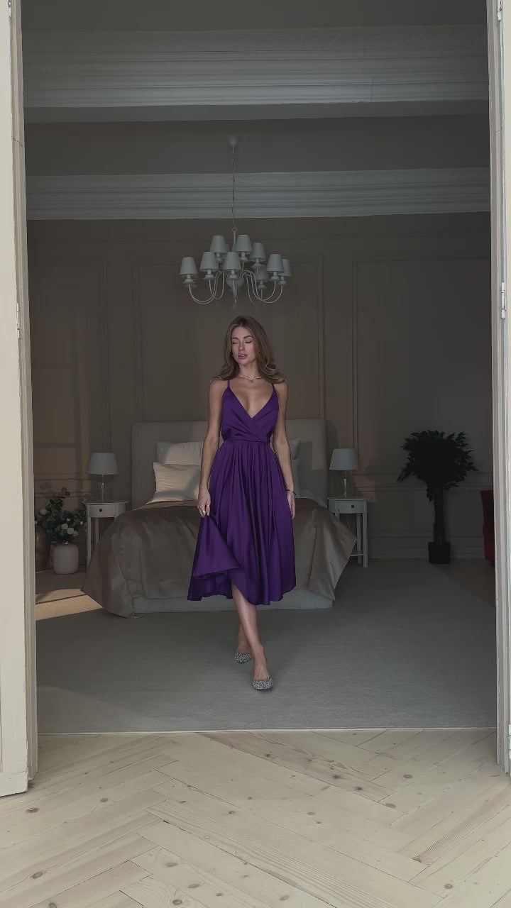 Purple silk slip midi dress with deep V-neck and open back modelled in motion — EvolveUA