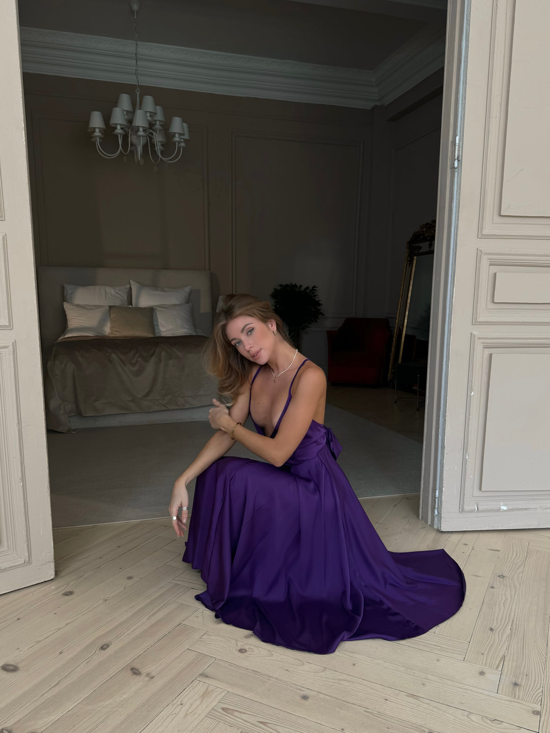 Purple silk midi dress with V-neckline — movement and drape shot