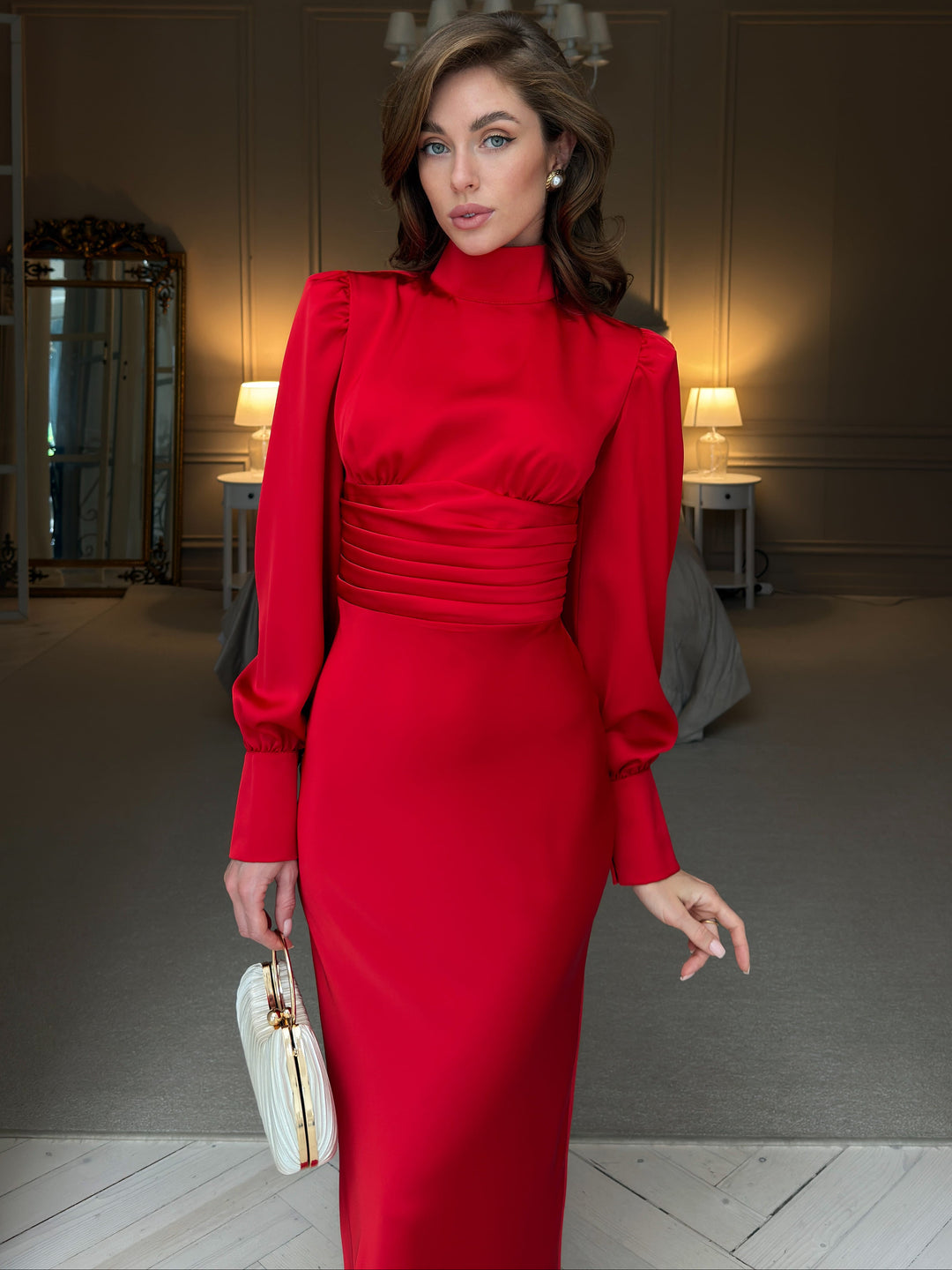 Red satin midi dress, front view from collar to skirt: gathered bodice, wide pleated corset-style waistband, long bishop sleeves and fitted pencil silhouette.