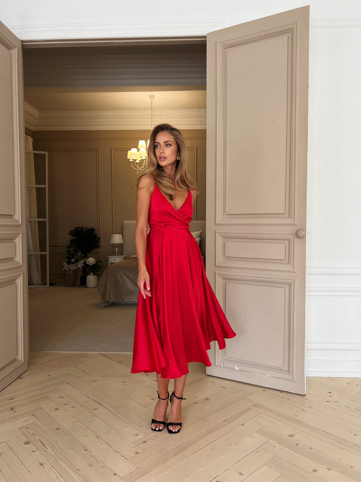 Red silk slip midi dress with open back and bow tie detail — back view