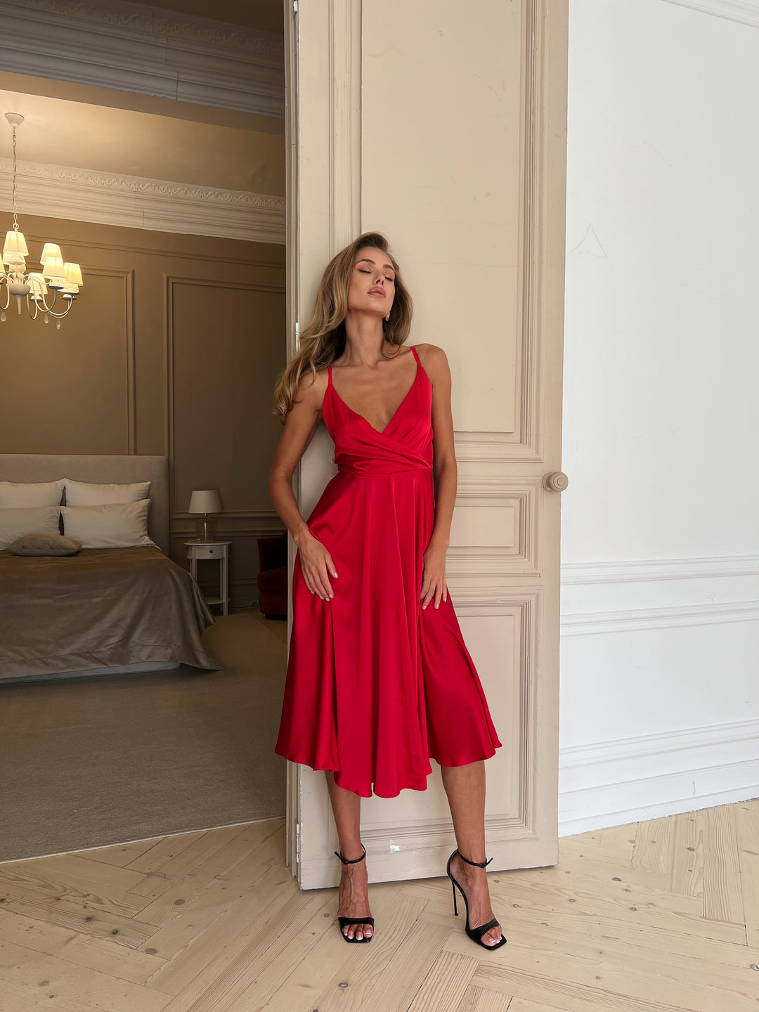 Red silk slip dress with deep V-neckline — editorial close up shot