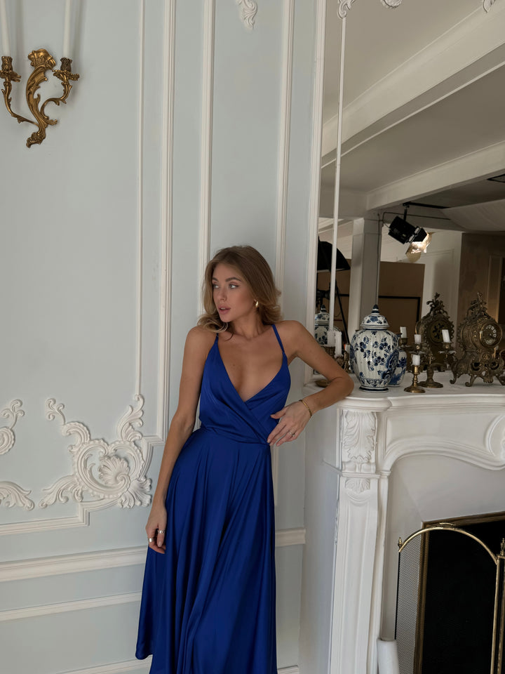 Royal blue silk satin midi dress with open bow back — styled look
