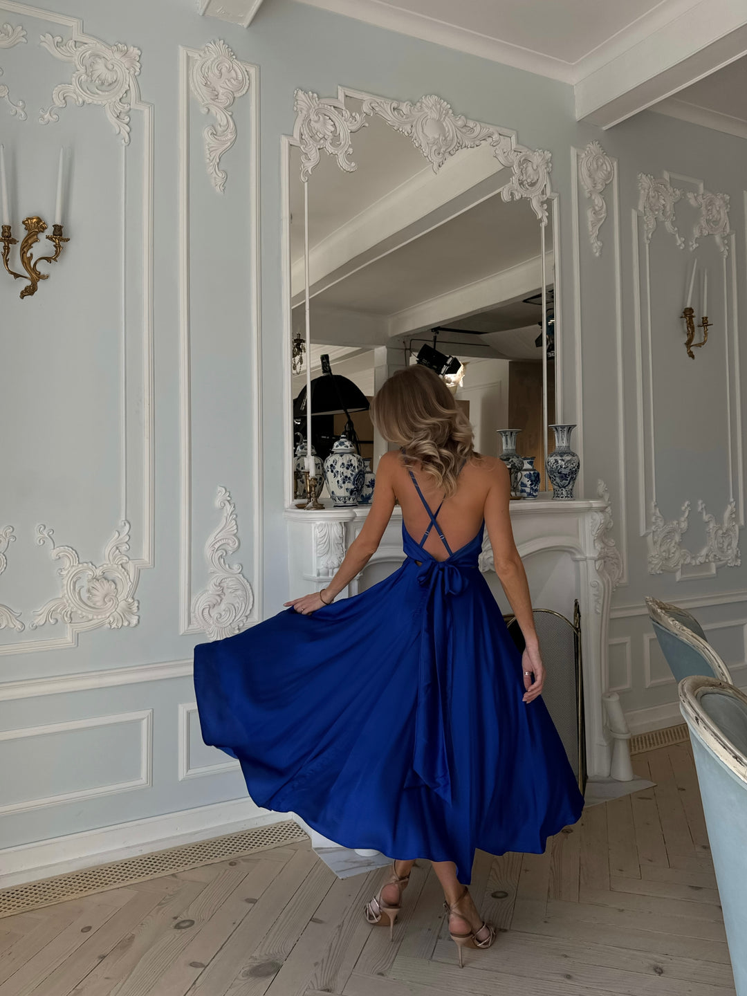 Royal blue silk midi dress with V-neckline — movement and drape shot