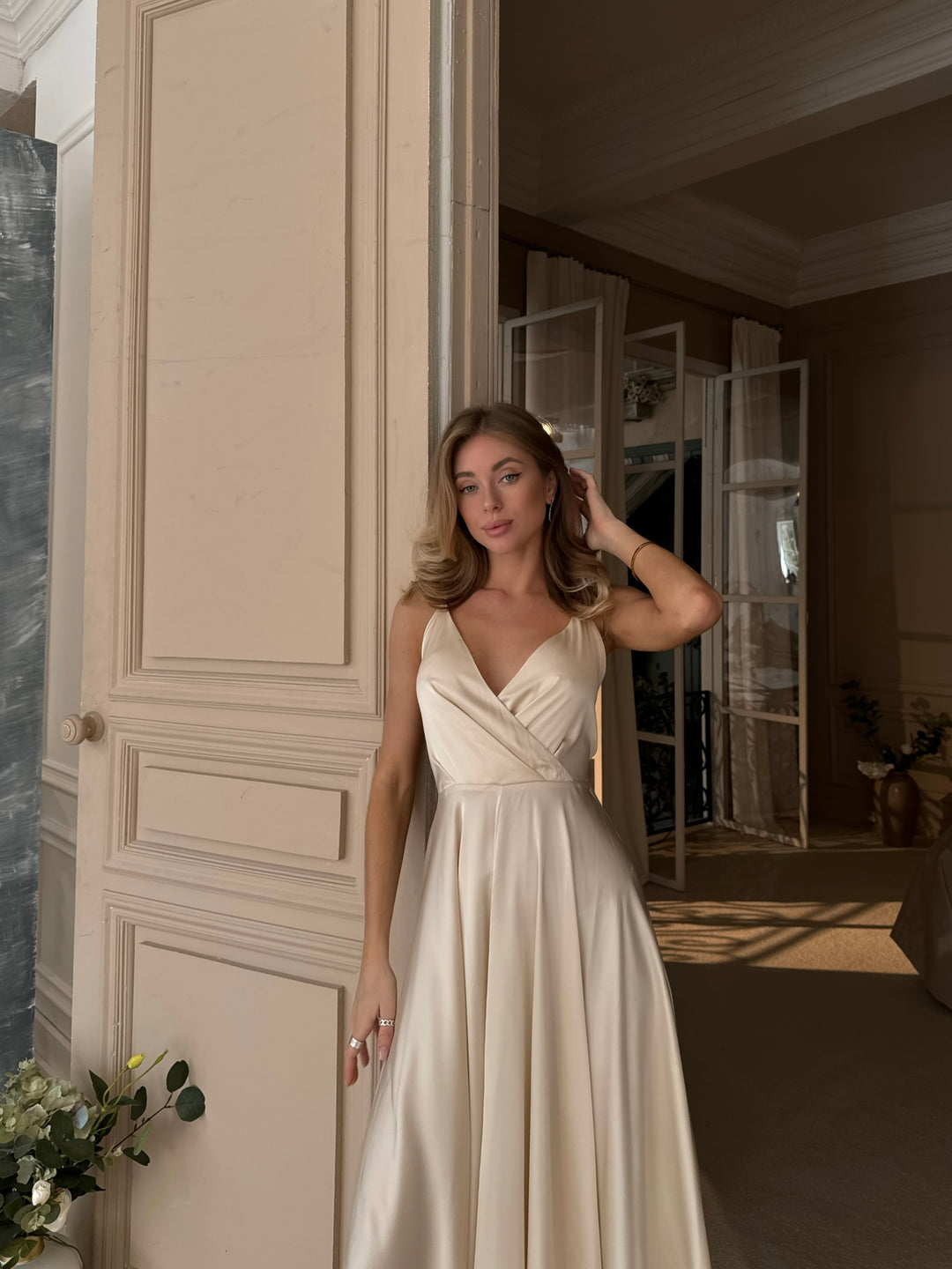 Back view of vanilla silk midi dress showing open back and bow tie closure