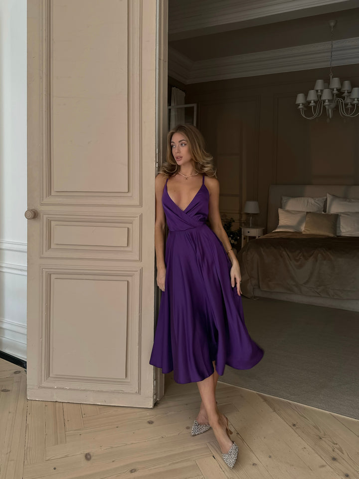 Violet purple silk slip dress with elegant open bow back — styled look
