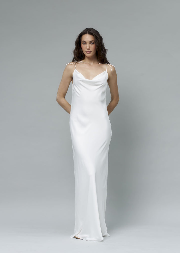 White satin cowl neck maxi slip dress, model posing with hands on hips, elegant minimalist bridal look