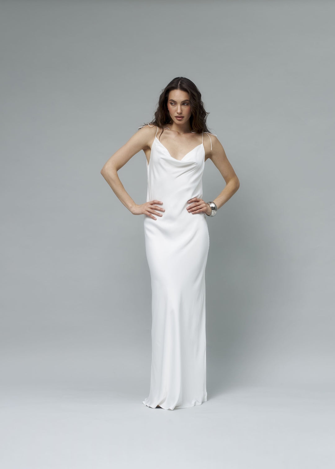 White satin maxi slip dress with cowl neckline and delicate spaghetti straps, full front view, minimalist bridal gown