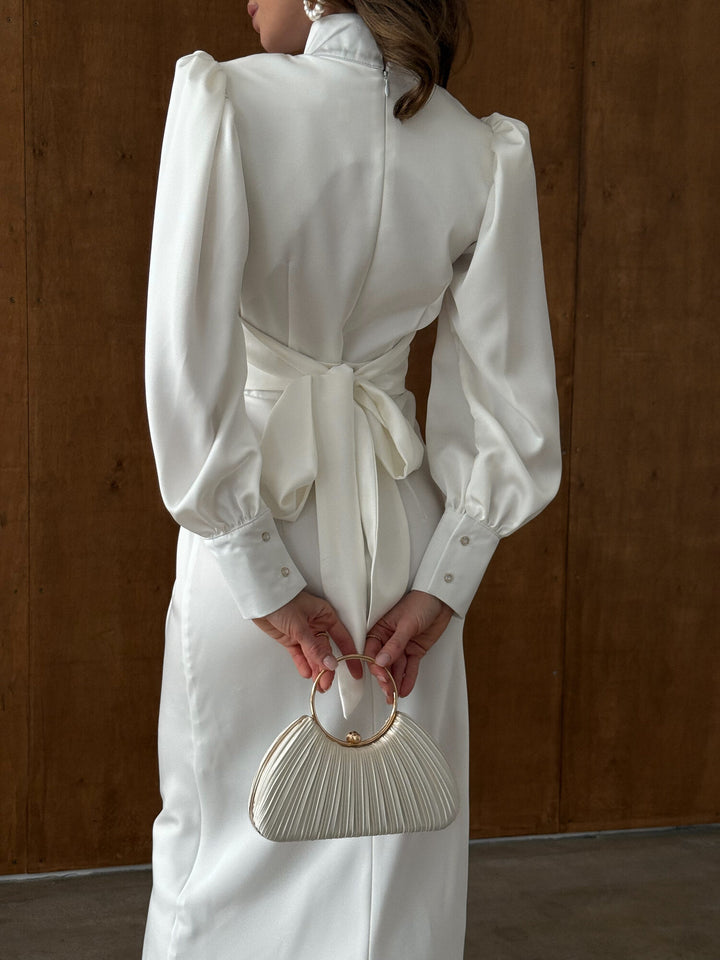 Back detail of white satin dress showing functional bow tie and hidden zipper closure