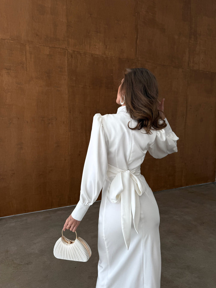 White satin midi dress back bow tie close up — adjustable functional closure detail