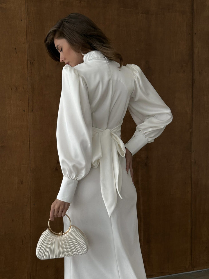 White satin midi dress with high neckline and bishop sleeves — engagement celebration look