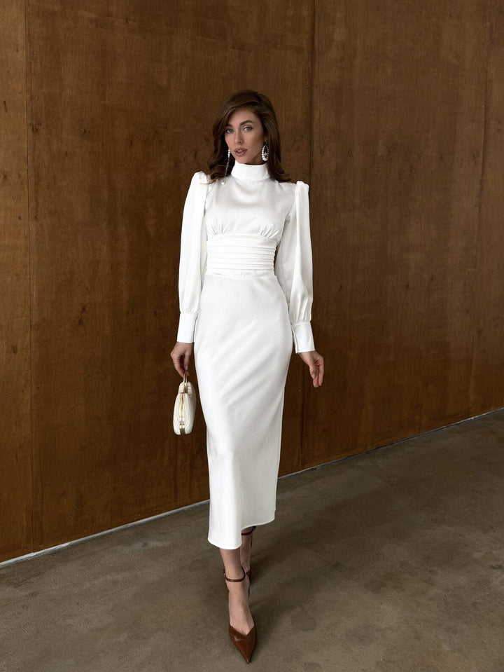 White satin midi dress with high neckline, long balloon sleeves and ruched waist — full length front view